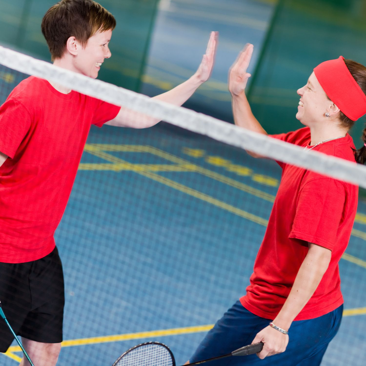 A portable badminton net set up on a lawn